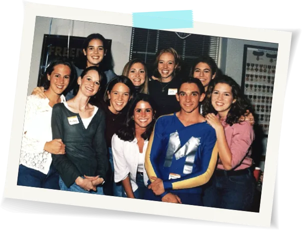 Ryan Deiss in a blue Millennium Man costume at a 1999 costume party, standing with a group of students